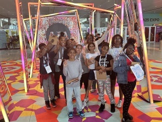 Boston fifth graders posing in the entryway at AIA25.