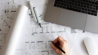 Architect taking notes on sketches