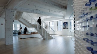 Gentleman walking down stairwell in an office
