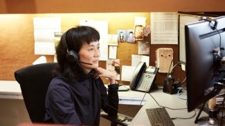 Female AIA member at computer 