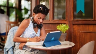Woman on laptop taking notes