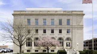 square white building with american flag to the right
