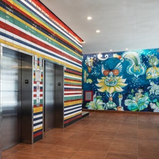 Colored tile on elevator core derived from flags of Latin American countries, mural painted by Aurelio del Muro and Marta Blair