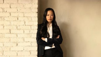 Evelyn Lee standing in front of brick wall