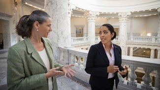 Architect and politician discussing policy as they walk together.