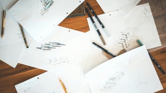 Pencils and pens on architectural drawings