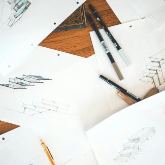 Pencils and pens on architectural drawings