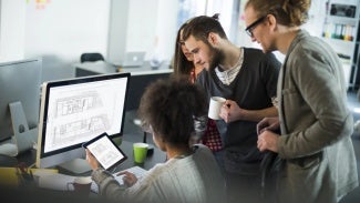 Group of colleagues working at a computer