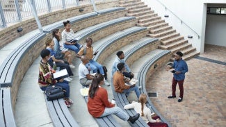 Male teacher lecturing at an outdoor classroom amphitheater